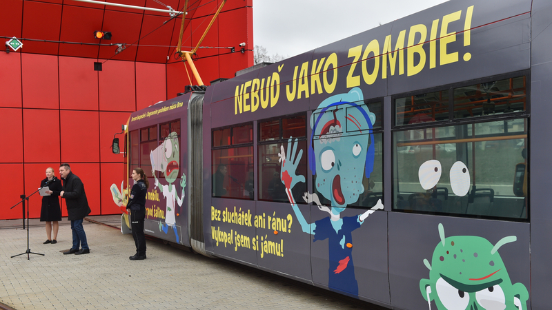 Brněnský dopravní podnik představil 31. března 2022 tramvaj polepenou motivy oživlých mrtvol, takzvaných zombie. Je symbolem letošní kampaně Brnem bezpečně. Postavy zombie na polepu tramvaje i na plakátech uvnitř varují před nebezpečným chováním v městském provozu ve vztahu k vozům hromadné dopravy. Druhý zleva je generální ředitel dopravního podniku Miloš Havránek.
